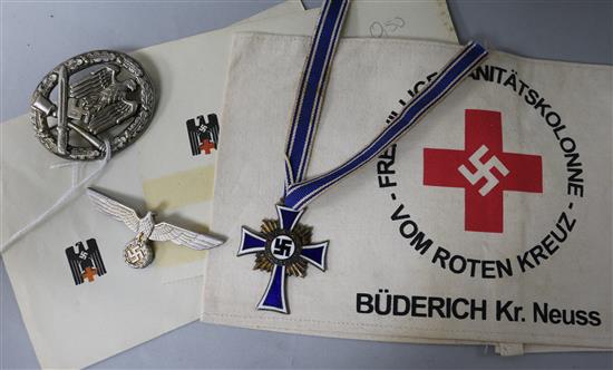 A German Red Cross armband and paperwork, a mothers cross, a general assault badge